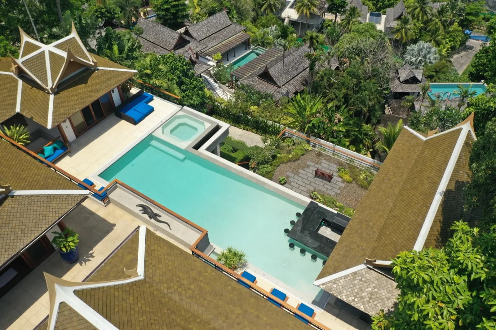 Overhead view of a villa pool with spa and sunken bar surrounded by lush jungle