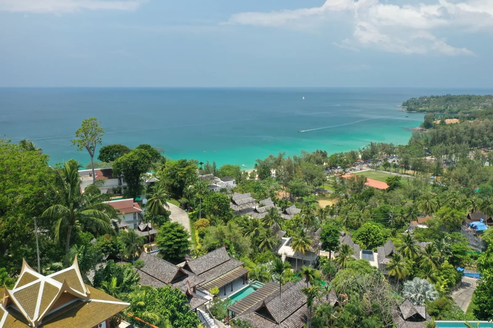 Drone view from the villa over the jungle to a turquoise Andaman Sea bay