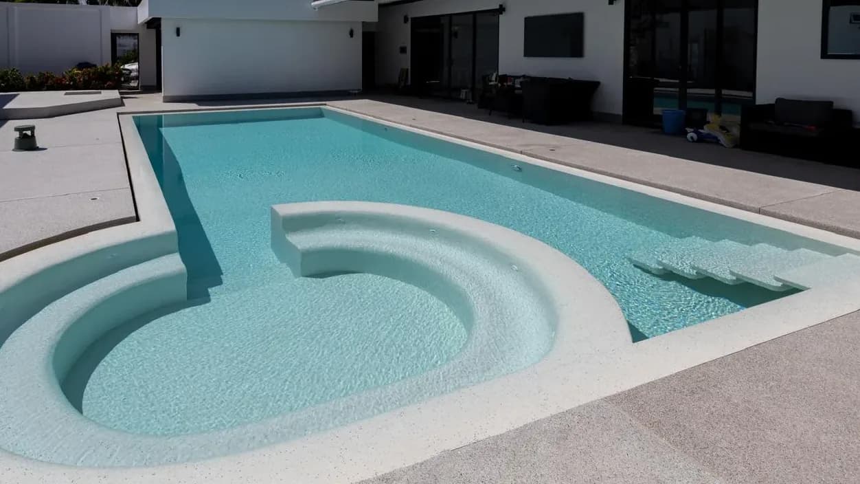Family pool with curved spa after renovation