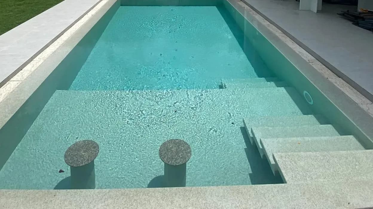 Pool with in-water bar stools after renovation