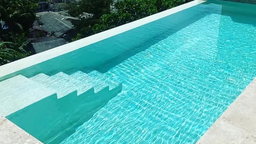 Hillside pool with a town view after renovation