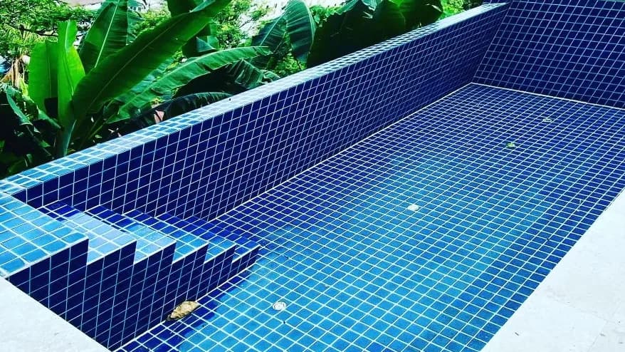 Hillside pool with a town view before renovation