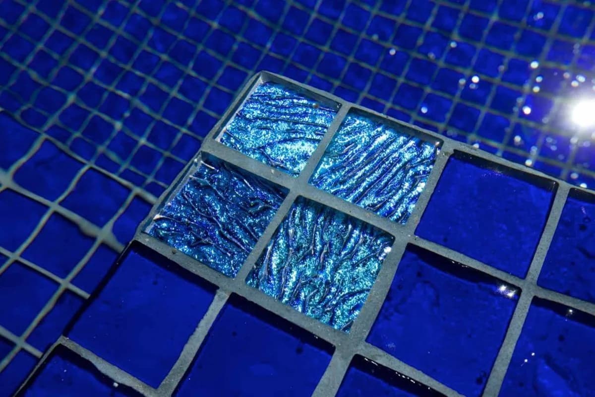Jewel accent tiles set into a deep blue pool wall