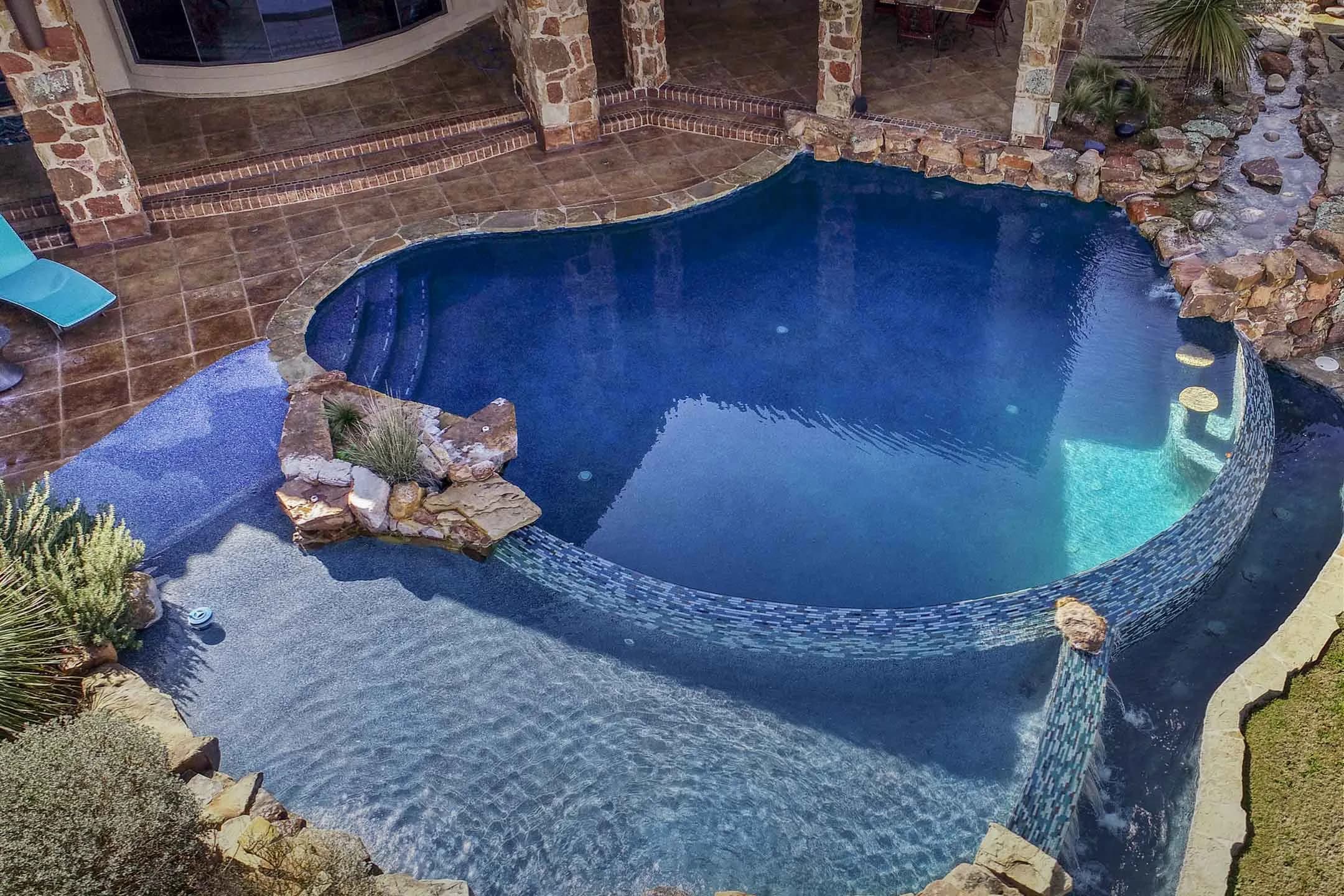Resurfaced PebbleTec pool at dusk
