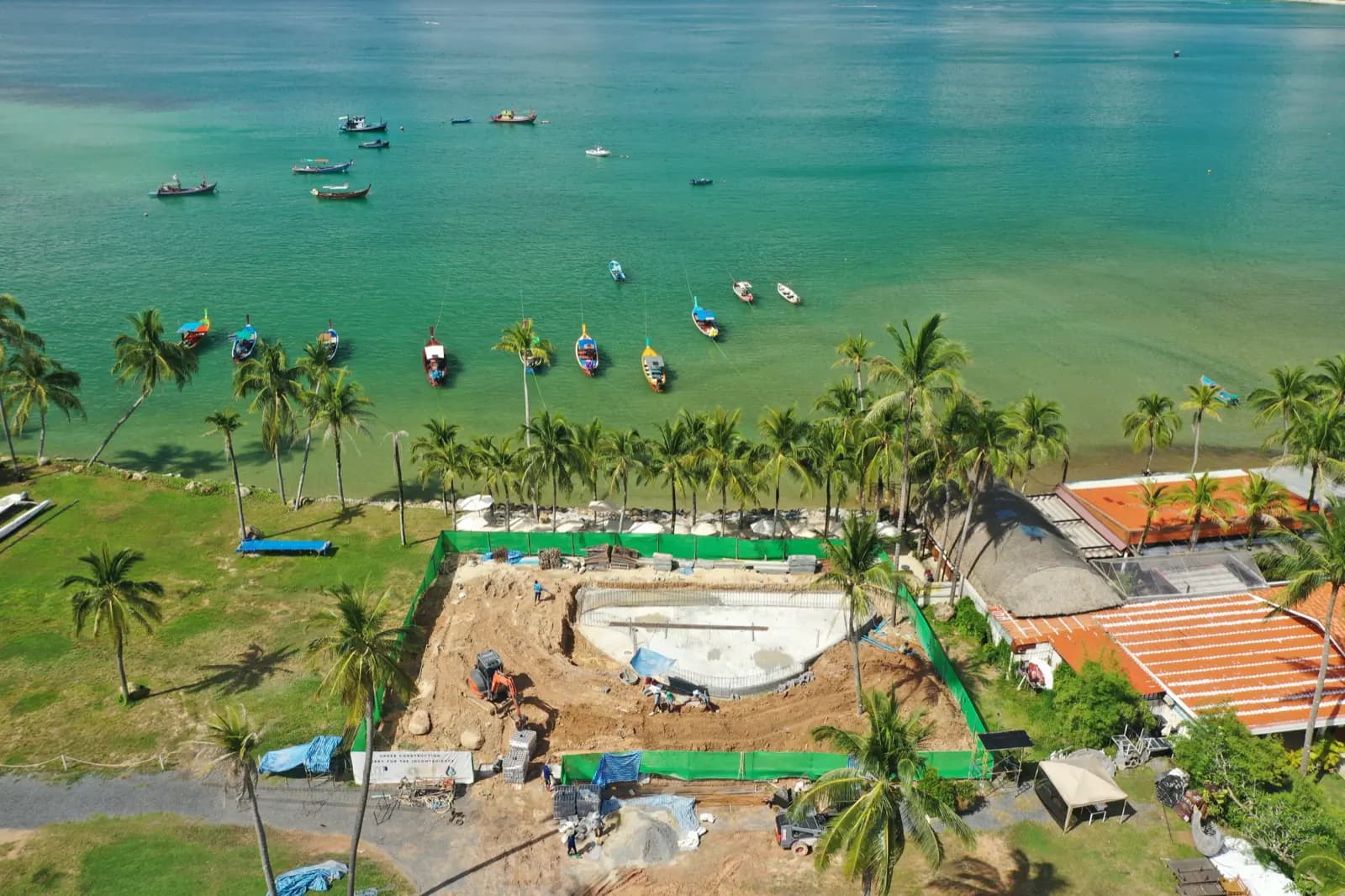 Beachfront pool construction site beside the bay before completion